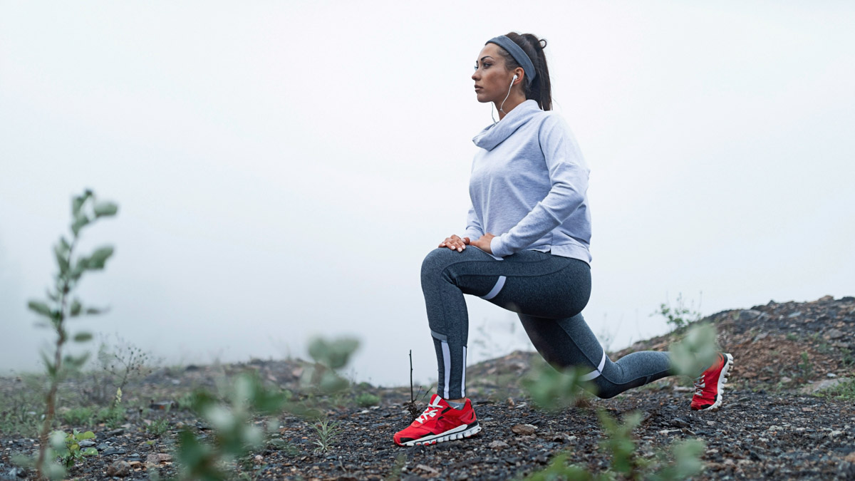 5 Pre Running Stretches And Exercises From Trainingpeaks Coach Mike Ricci Young Athletic Woman Stretching Before A Trail Run In Foggy Weather
