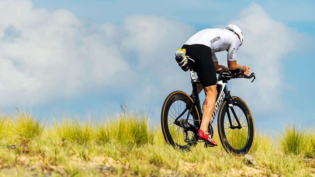 Ironman World Championships Hawai’i 2022 A Male Cyclist Rides A Time Trial Bike On A Road