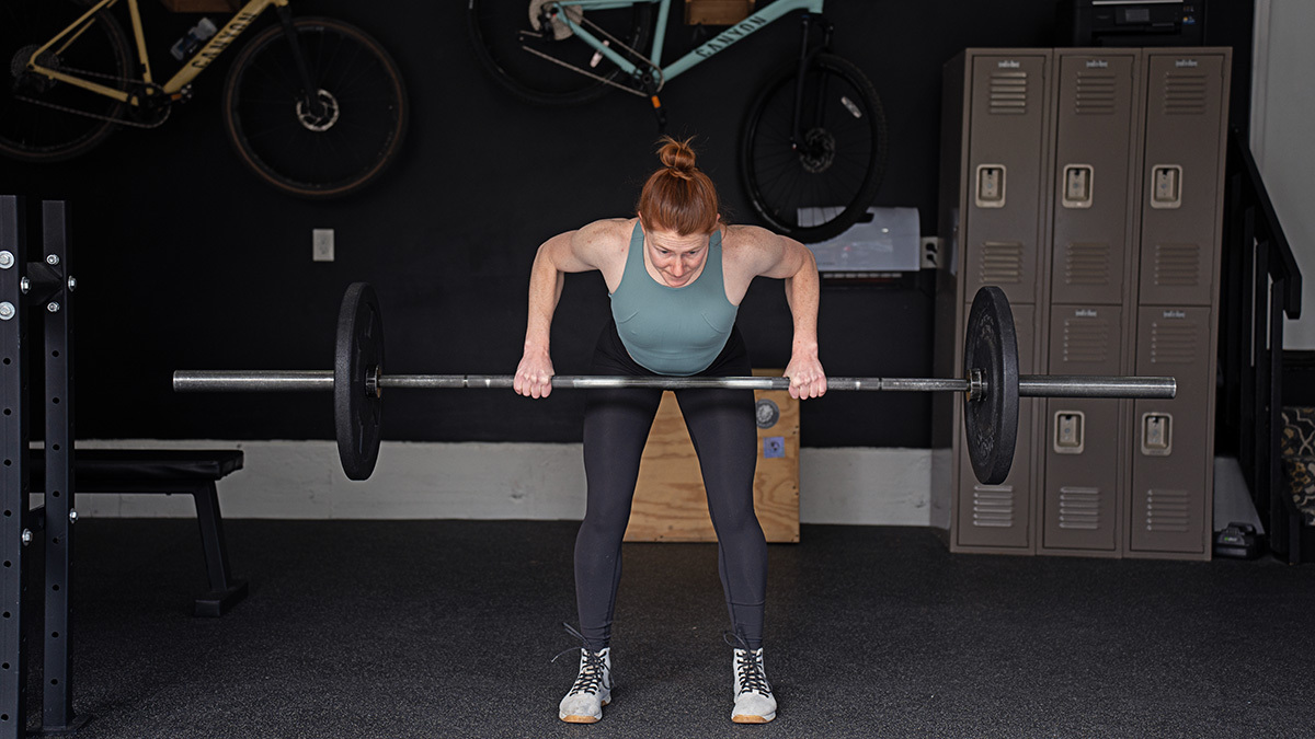 5 Ways Strength Improves Your Cycling Cycling Athlete In The Gym Performing A Bent Over Row With A Barbell During Strength Training